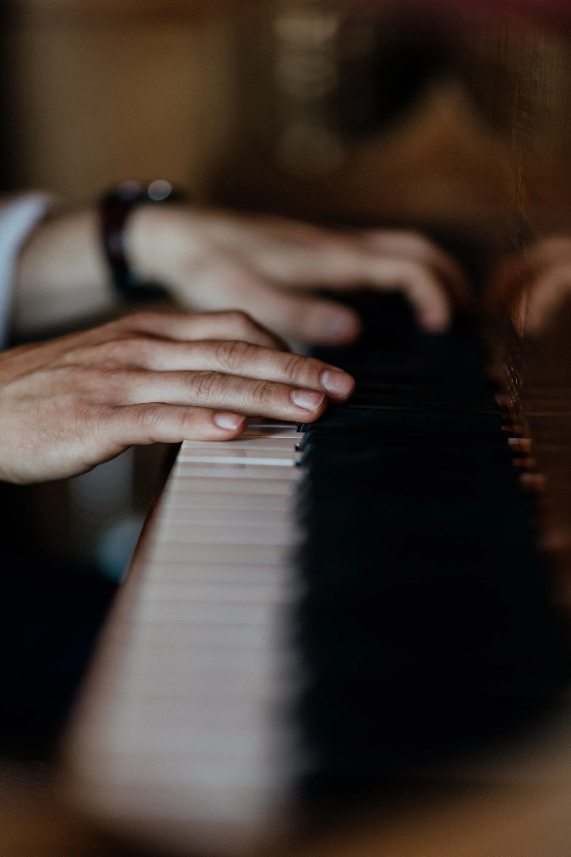 Close-up of Finn’s hands on the keys of a grand piano